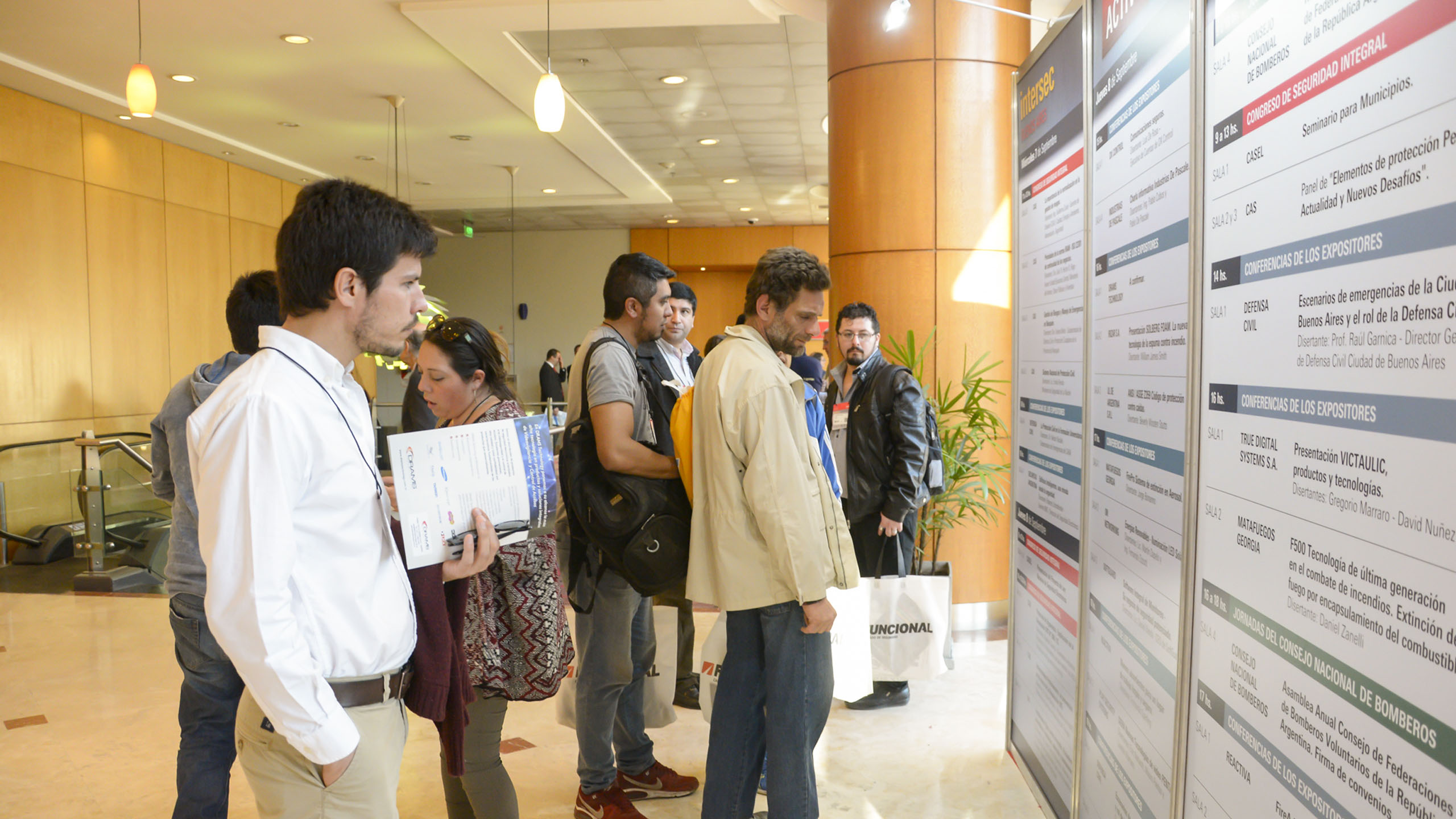 People checking the conference schedule